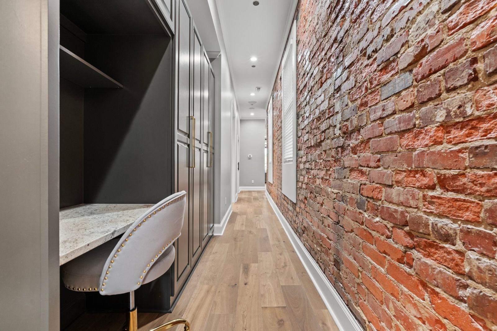 Aurelia Suite hallway workspace and wardrobes along the brick wall