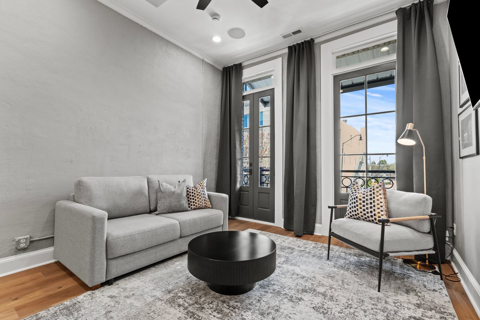 Noir Suite living room with French doors to the balcony