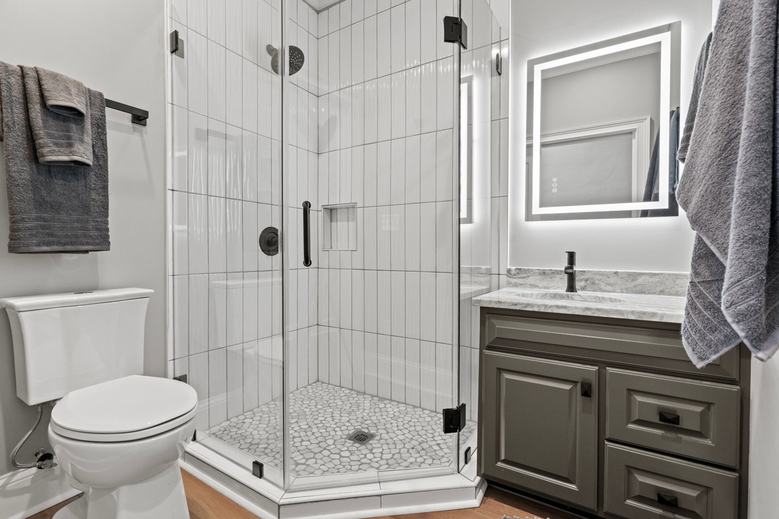 Noir Suite bathroom with glass shower and black fixtures